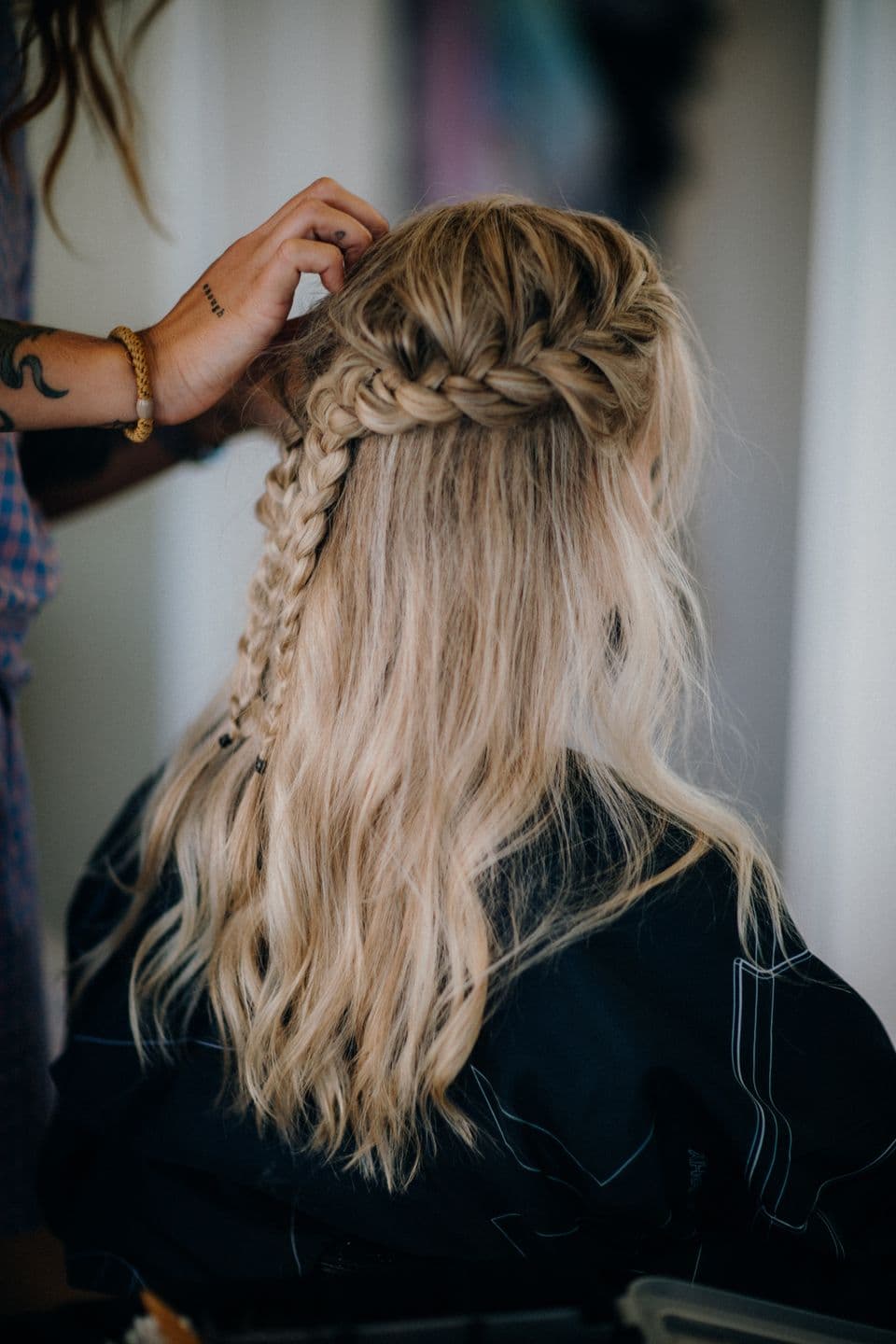 A stylist braiding a client's hair